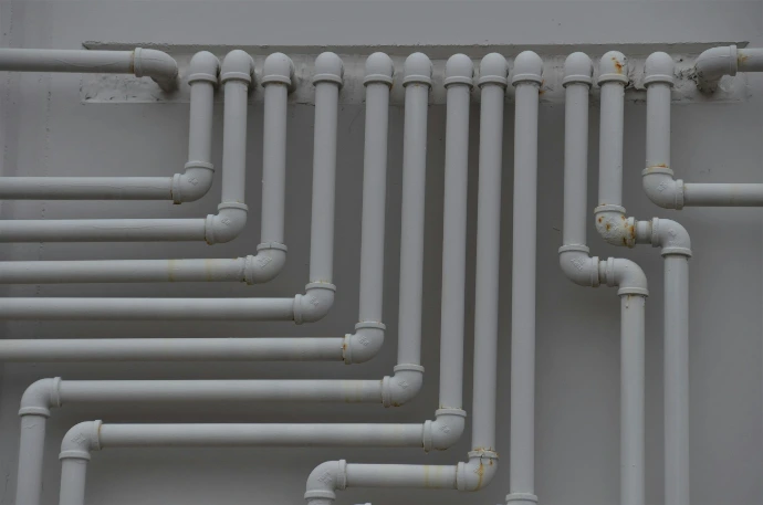 a close up of a bunch of pipes on a wall